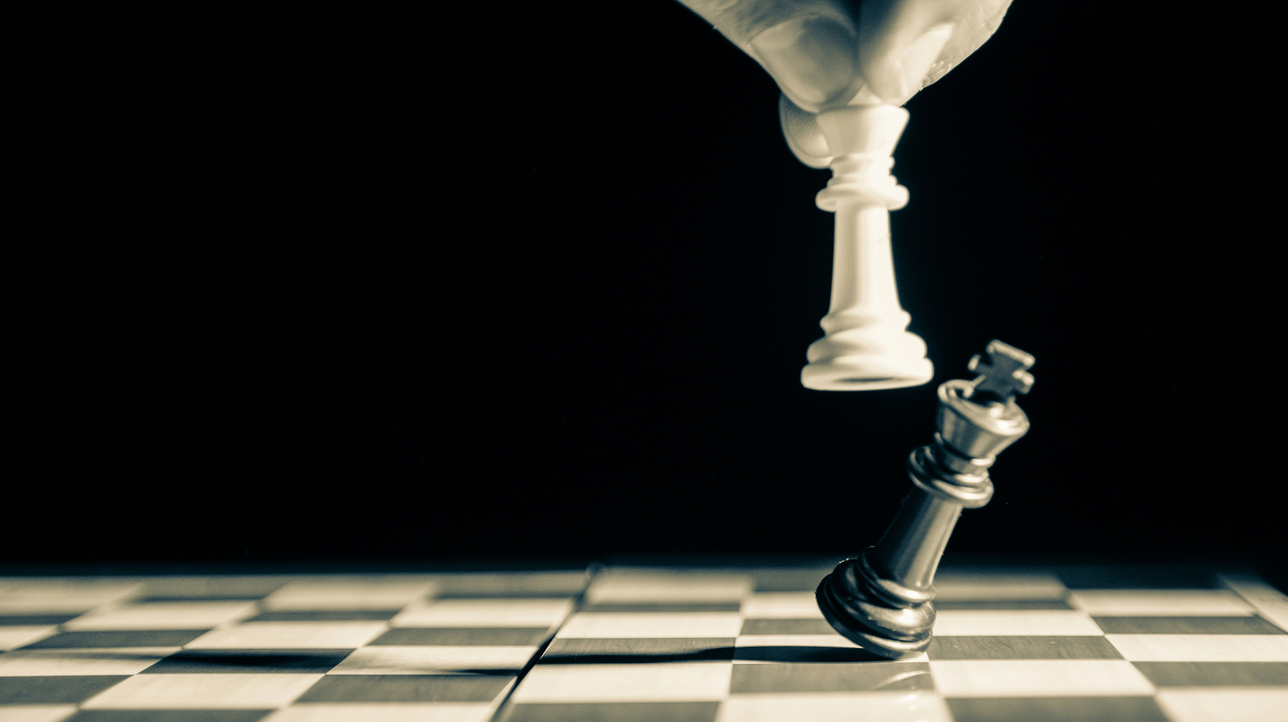 chess piece knocking over another chess piece