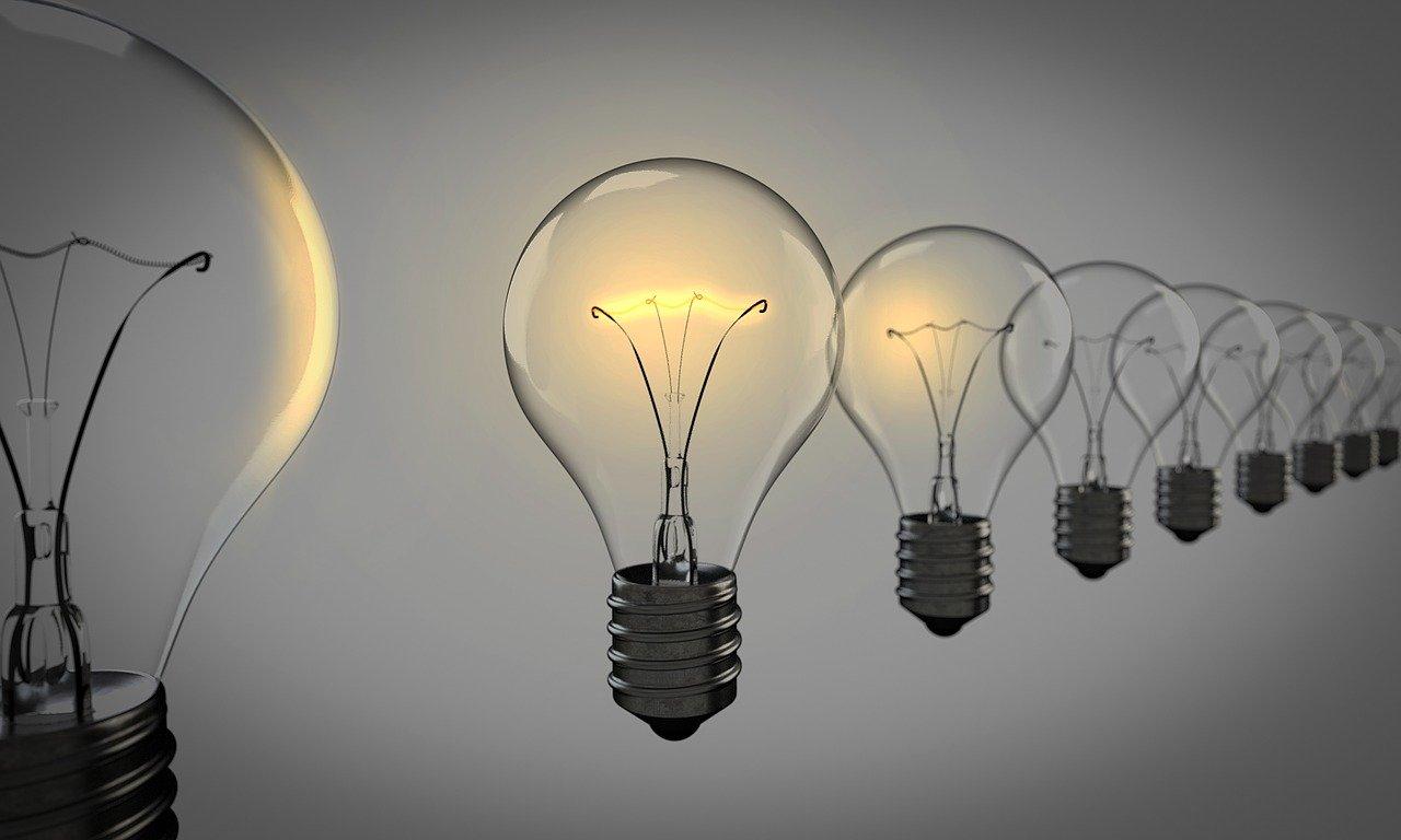 A row of light bulbs, some glowing brightly