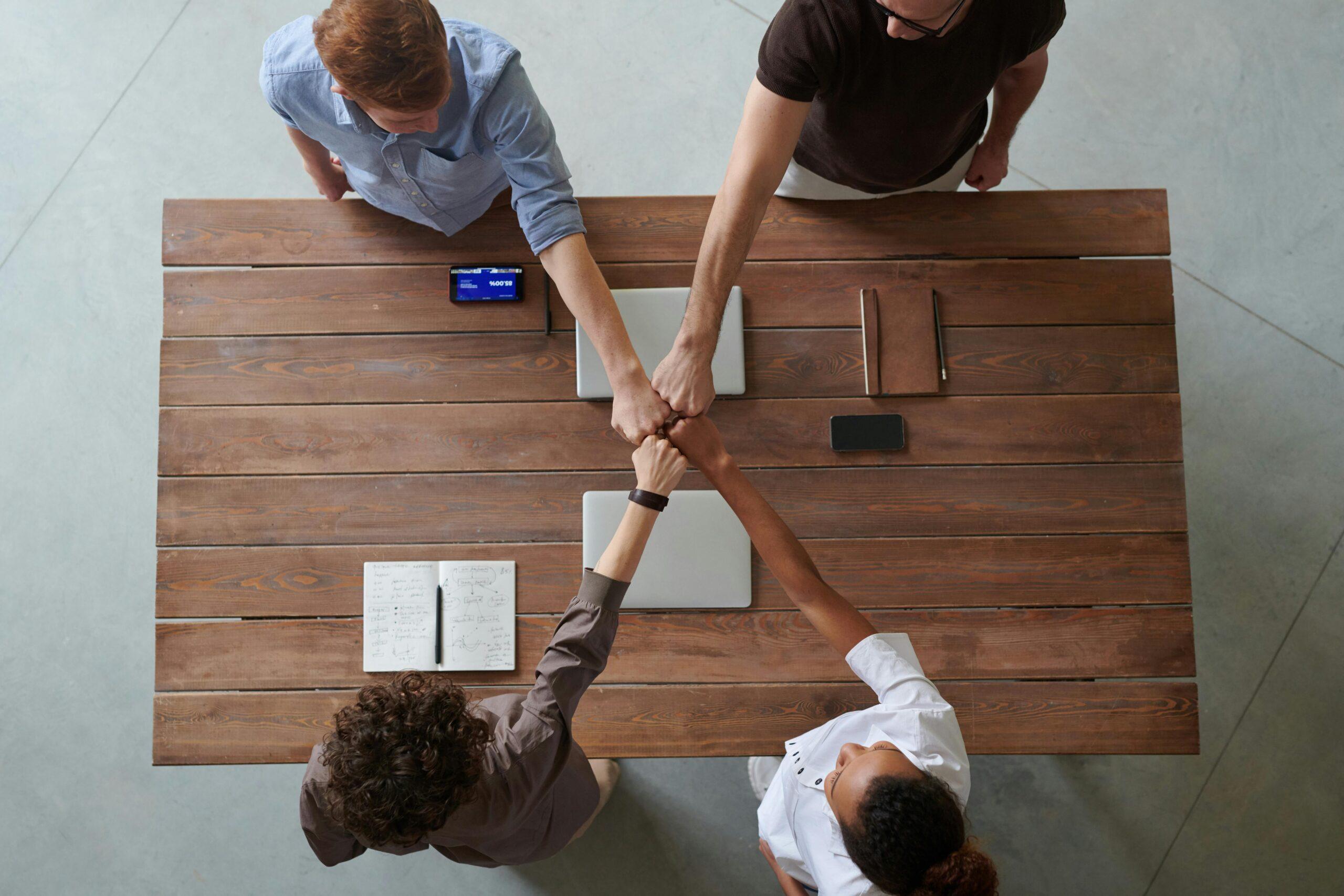 business partners making an "X" with their fists